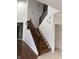 Elegant staircase with wood steps and railing, leading to an upper floor with chandelier at 7522 Timberfield Ln, Indianapolis, IN 46259