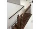 Elegant wood staircase featuring stained wood steps, decorative balusters and railing at 7522 Timberfield Ln, Indianapolis, IN 46259