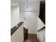 Staircase with wood steps and railing, leading to a chandelier and upper floor at 7522 Timberfield Ln, Indianapolis, IN 46259