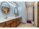 Well-lit bathroom featuring double sinks, wooden cabinetry, and a shower with neutral decor at 7856 Trotwood Cir, Indianapolis, IN 46256