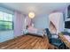 Bedroom with natural light, hardwood flooring, a workstation, and modern décor at 7856 Trotwood Cir, Indianapolis, IN 46256