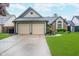 Charming single-Gathering home with a well-manicured front yard and attached two-car garage at 7856 Trotwood Cir, Indianapolis, IN 46256
