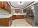 Functional kitchen featuring wood cabinets, stainless steel appliances, and plenty of counter space at 7856 Trotwood Cir, Indianapolis, IN 46256