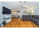 Bright living room featuring wood floors, vaulted ceilings with skylight, and a cozy gray sofa at 7856 Trotwood Cir, Indianapolis, IN 46256