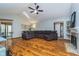 Bright living room featuring wood floors, vaulted ceilings with skylight, and a cozy gray sofa at 7856 Trotwood Cir, Indianapolis, IN 46256