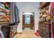 Large walk-in closet with ample storage space for clothes and shoes with a view of the bathroom at 7856 Trotwood Cir, Indianapolis, IN 46256