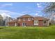 Large backyard featuring a well-kept lawn, trampoline, and access to the home at 8031 Edgewood Ct, Plainfield, IN 46168