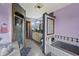 Well-lit bathroom featuring a soaking tub, a shower, a vanity, glass block window, and colorful walls at 8031 Edgewood Ct, Plainfield, IN 46168