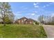 Wide exterior view of a brick home with a circular driveway and lush lawn at 8031 Edgewood Ct, Plainfield, IN 46168