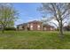 Expansive exterior view of a brick home with a well-manicured lawn and mature trees at 8031 Edgewood Ct, Plainfield, IN 46168