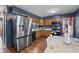 Modern kitchen with stainless steel appliances and wood cabinets, perfect for culinary adventures at 8031 Edgewood Ct, Plainfield, IN 46168