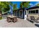 Back patio showcasing an outdoor dining set, umbrella, and various seating options at 845 W 77Th St S Dr, Indianapolis, IN 46260