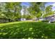 Large, well-maintained backyard featuring a lush green lawn and mature trees at 845 W 77Th St S Dr, Indianapolis, IN 46260