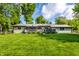 Lush backyard showcasing a deck, stone accents, and ample green space, perfect for outdoor enjoyment at 845 W 77Th St S Dr, Indianapolis, IN 46260