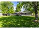 Well-manicured backyard with a covered deck and lush greenery providing privacy and a relaxing atmosphere at 845 W 77Th St S Dr, Indianapolis, IN 46260