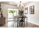 Dining area featuring a wood table, open sliding door, and contemporary lighting at 845 W 77Th St S Dr, Indianapolis, IN 46260