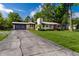 Charming single-story home with stone accents, a well-manicured lawn, and an attached two car garage at 845 W 77Th St S Dr, Indianapolis, IN 46260