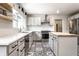 Bright kitchen with white cabinets, light countertops, and stylish black and white patterned tile flooring at 845 W 77Th St S Dr, Indianapolis, IN 46260