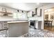 Bright kitchen with stainless steel appliances, light countertops, and black and white patterned floors at 845 W 77Th St S Dr, Indianapolis, IN 46260