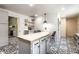 Open kitchen with central island, butcher block countertop, pendant lighting, and decorative tile flooring at 845 W 77Th St S Dr, Indianapolis, IN 46260