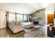 Inviting living room with stone fireplace, a comfortable sectional sofa, and large windows at 845 W 77Th St S Dr, Indianapolis, IN 46260