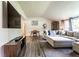 Bright living room with hardwood floors, a modern sectional sofa, and a wall-mounted television at 845 W 77Th St S Dr, Indianapolis, IN 46260