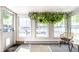 Cozy sun room with large windows, neutral carpet, and a decorative hanging plant at 845 W 77Th St S Dr, Indianapolis, IN 46260