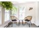 Bright sun room featuring two wicker chairs and large windows allowing for ample natural light at 845 W 77Th St S Dr, Indianapolis, IN 46260