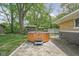 Backyard patio area with a hot tub and shed at 846 W 56Th St, Indianapolis, IN 46228