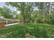 Large backyard featuring mature trees, a swing set, shed, hot tub and patio at 846 W 56Th St, Indianapolis, IN 46228