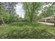 Large backyard featuring mature trees, a swing set, shed, and patio at 846 W 56Th St, Indianapolis, IN 46228