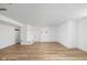 Spacious basement featuring wood-look flooring, white walls, and built-in shelving for customizable living space at 846 W 56Th St, Indianapolis, IN 46228