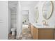 Bathroom featuring double sinks with gold fixtures and a toilet at 846 W 56Th St, Indianapolis, IN 46228