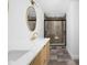 Elegant bathroom with stylish mirrors, a sink, and a modern glass-enclosed shower at 846 W 56Th St, Indianapolis, IN 46228