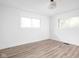 Bedroom featuring two large windows, light laminate floor, and neutral paint at 846 W 56Th St, Indianapolis, IN 46228