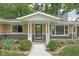 A welcoming entrance with updated landscaping, modern windows, and a covered porch at 846 W 56Th St, Indianapolis, IN 46228