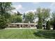 Stunning ranch-style home featuring a brick facade, a well-manicured lawn, and mature trees at 846 W 56Th St, Indianapolis, IN 46228