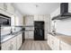 White kitchen featuring subway tile backsplash, stainless steel appliances, and updated cabinets at 846 W 56Th St, Indianapolis, IN 46228