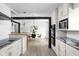 Modern kitchen with stainless steel appliances, white cabinets, and an island bar at 846 W 56Th St, Indianapolis, IN 46228