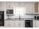 Updated kitchen features gray countertops, white cabinets, and stainless steel appliances at 846 W 56Th St, Indianapolis, IN 46228