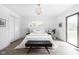 Bright main bedroom features a comfortable queen bed and closet with a large window and door at 846 W 56Th St, Indianapolis, IN 46228