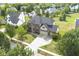 Aerial view of a two-story brick home with a three-car garage in a residential neighborhood at 9037 Carnation Dr, Noblesville, IN 46060