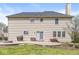 Large backyard with lush green lawn, patio, grill, and mature trees at 9037 Carnation Dr, Noblesville, IN 46060