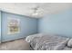 Bright bedroom with a large window, neutral carpet, and a comfortable bed providing a relaxing atmosphere at 9037 Carnation Dr, Noblesville, IN 46060