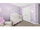 Charming Bedroom with a white crib, lavender walls, and sweet decorations creating a cozy and inviting space at 9037 Carnation Dr, Noblesville, IN 46060