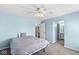 Airy bedroom showcases a ceiling fan, cozy bed, and access to a private bathroom enhancing comfort and convenience at 9037 Carnation Dr, Noblesville, IN 46060