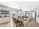 Dining room with a wooden table and chairs, chandelier, and sliding doors to the backyard at 9037 Carnation Dr, Noblesville, IN 46060