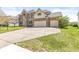 Two-story brick home with a three-car garage and well-manicured lawn at 9037 Carnation Dr, Noblesville, IN 46060