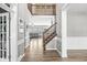 Stunning home foyer with wood floors and staircase leading to the second floor with neutral paint and white trim at 9037 Carnation Dr, Noblesville, IN 46060