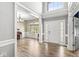 Welcoming home foyer with hardwood floors and natural light that highlights the home's grand entrance and dining space at 9037 Carnation Dr, Noblesville, IN 46060